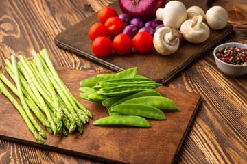 Fresh green vegetables on a wooden table. Background. Healthy lifestyle