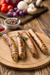 Grilled sausages with sauce ketchup on a wooden table