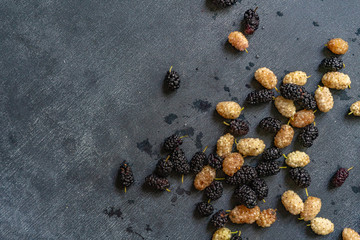 mulberry berries of white and black color macro shot