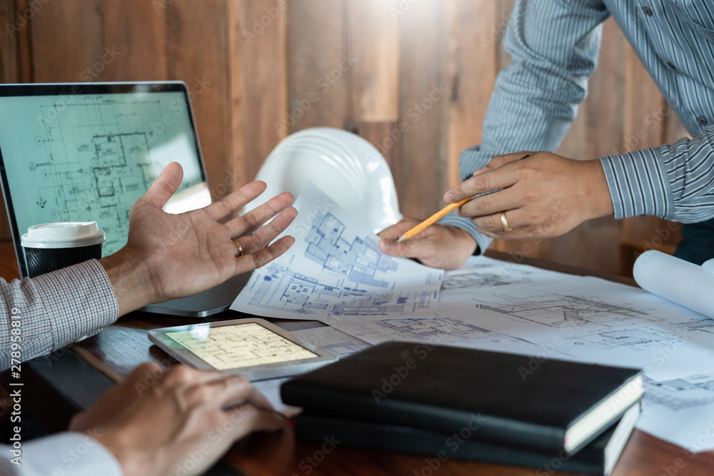 Poster confident engineer team working with blue print with architect equipment discussing and planning wor