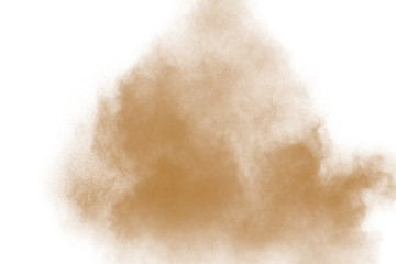 Freeze motion of brown dust explosion on white background. Throwing brown powder out of hand...
