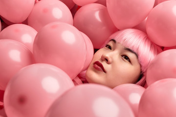 Fototapeta na wymiar Pink balloons on Asian female