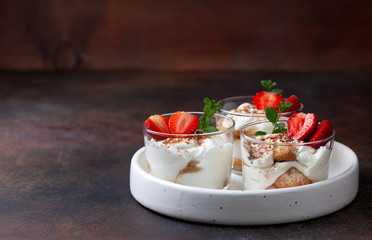 tiramisu in a glass with fresh strawberries