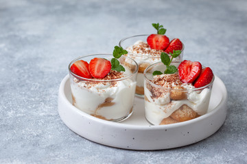 tiramisu in a glass with fresh strawberries