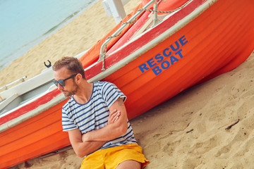 Rescue boat and lifeguard keeping the beach safe in summertime period.