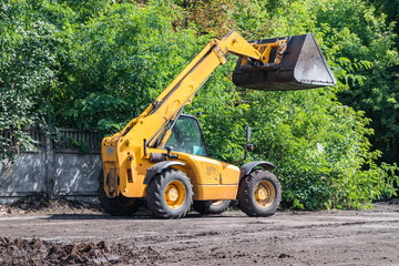 Obraz na płótnie Canvas Orange excavator on wheels, earthmoving machinery for construction and earthworks