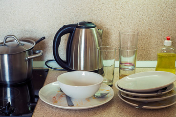 Dirty plates, cups and glasses on the kitchen table