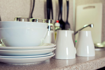 Clean plates,cups and glasses on the kitchen table