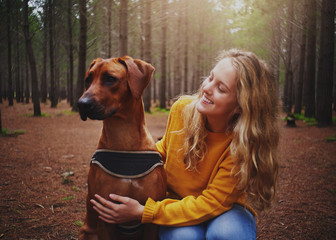 An attractive young woman loving her obedient dog