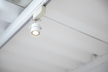 closeup of adjustable downlight installed on white ceiling.