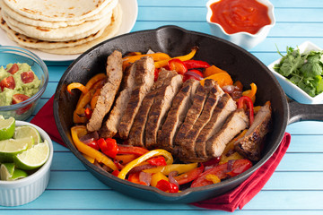 Beef Fajitas with Bell Peppers on a Blue Wood Table