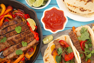 Beef Fajitas with Bell Peppers on a Blue Wood Table