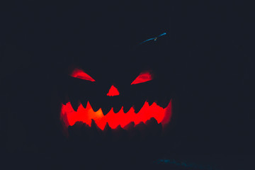 scary pumpkin for Halloween on a black background
