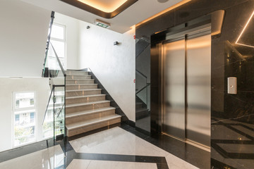 Interior of a shiny marble hotel corridor with elevator