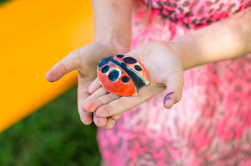 gypsum ladybirs in children hands