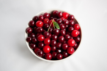 white plate with red cherry on white background