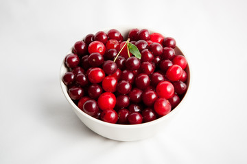 white plate with red cherry on white background