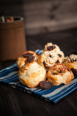 puff buns with raisins on a blue background