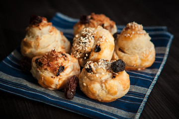  puff buns with raisins on a blue background