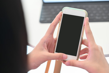 Top view woman's hand holding a mobile phone.