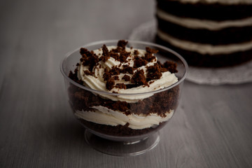 portioned chocolate cake with white cream in a cup