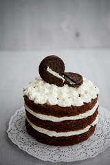 white chocolate cream cake decorated with biscuits