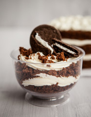portioned chocolate cake with white cream in a cup