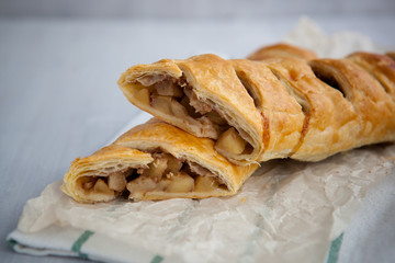 strudel with apple and cinnamon on a light towel, light background