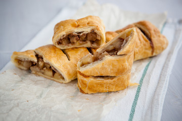 strudel with apple and cinnamon on a light towel, light background