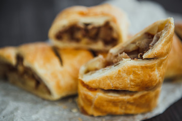 strudel with apple and cinnamon on a light towel, light background