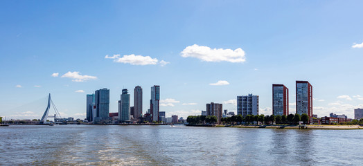 Fototapeta premium Cityscape and Erasmus bridge, sunny day. Rotterdam, Netherlands.