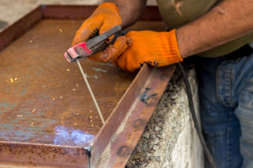 Fastening parts of metal under high temperature using a short circuit. Welding work on the metal.