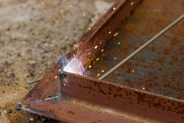 Fastening parts of metal under high temperature using a short circuit. Welding work on the metal.