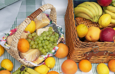 Ripe fruit in a wicker basket. Basket with cheese and fruit.