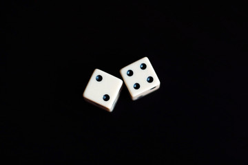 Two dice in a black background.