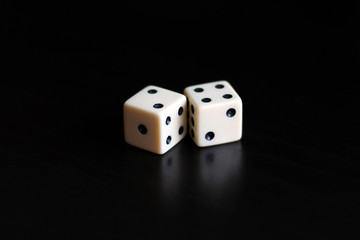 Two dice in a black background.