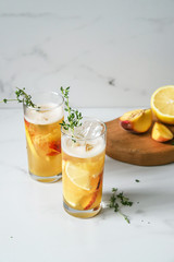 Fresh peach lemonade on light marble background