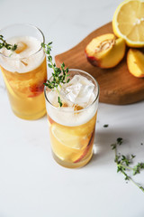 Fresh peach lemonade on light marble background. Top view