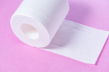 Eco-friendly white toilet paper on a pink background close-up