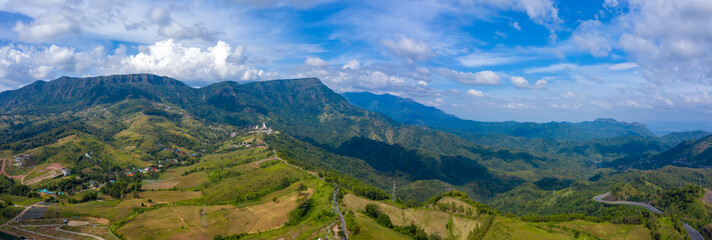 Fototapeta na wymiar panorama landscape aerial view mountain peak and blue sky with pagoda in Thailand