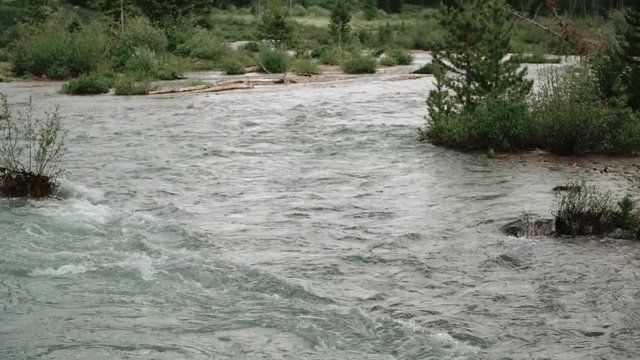 Water flowing down Colorado mountain river in slow motion