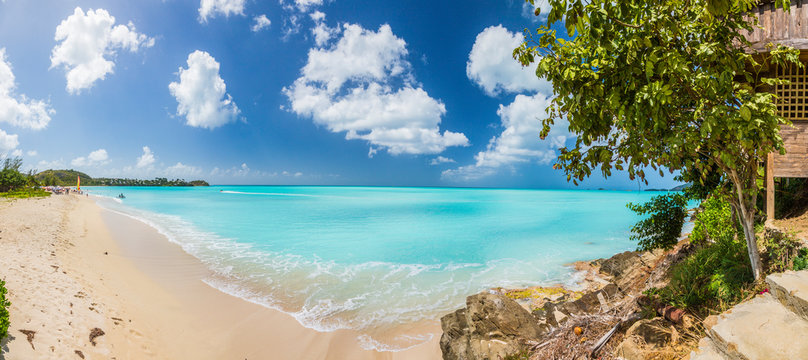 Panorama picture of whity sandy beach and turquoise waters on carrebian island of St. Maarten