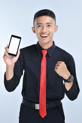 Success winner business man winning on cellphone app. Cheering business man looking at smartphone online gaming challenge or work deal