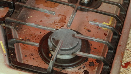 A disgusting, dirty stove badly in need of cleaning