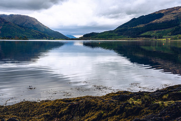 Scotland Highland valley mountain water foreground low angle Glen Etive Glen Coe