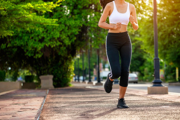Beautiful woman jogger outdoor living healthy lifestyle in city park. Concept sport and a healthy...