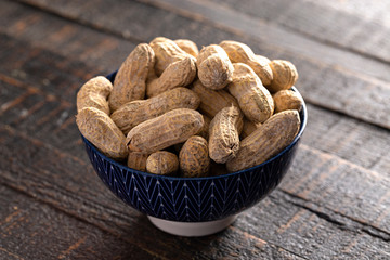 Raw In Shell Peanuts on a Wooden Kitchen Table