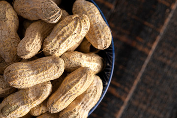 Raw In Shell Peanuts on a Wooden Kitchen Table