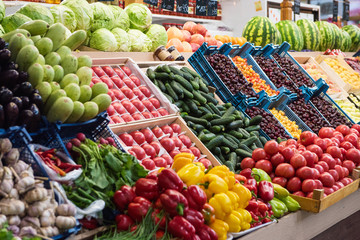 Vegetable farmer market counter: colorful various fresh organic healthy vegetables at grocery store. Healthy natural food concept