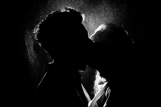black and white silhouette of a kissing couple